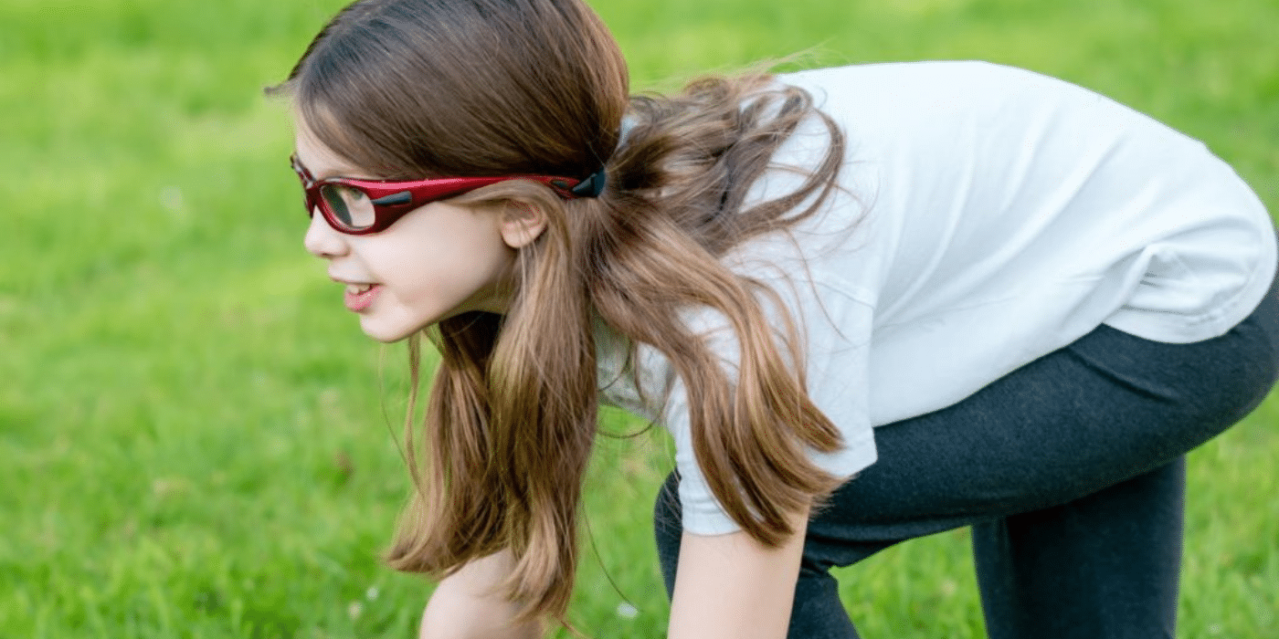 young girl wearing protective eyewear while playing sports
